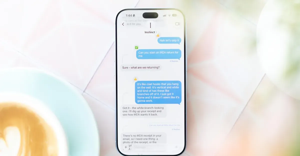Photo of a phone on a table showing Instinct AI texts.